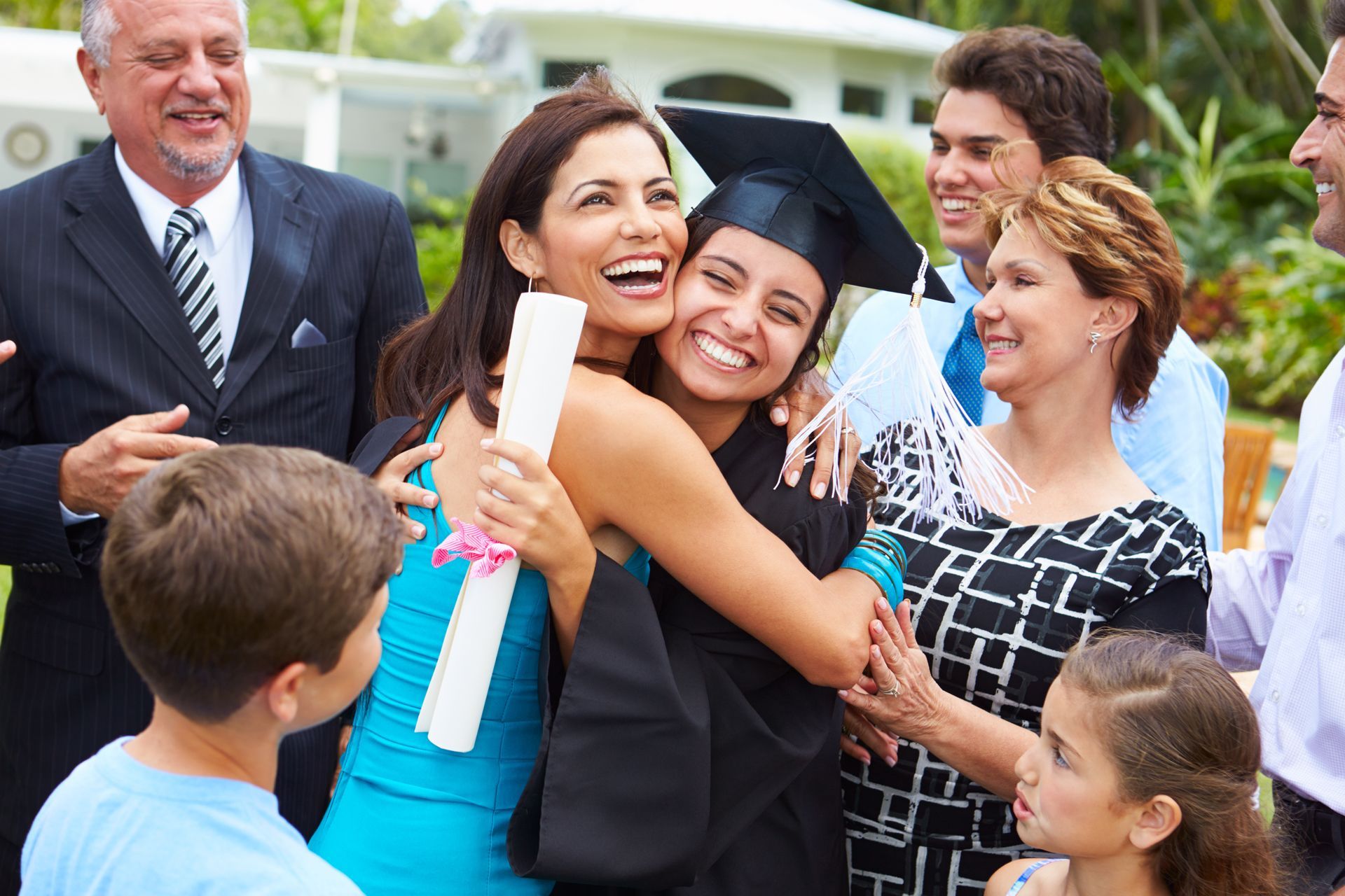 Graduation celebration with a graduate in a cap and gown.