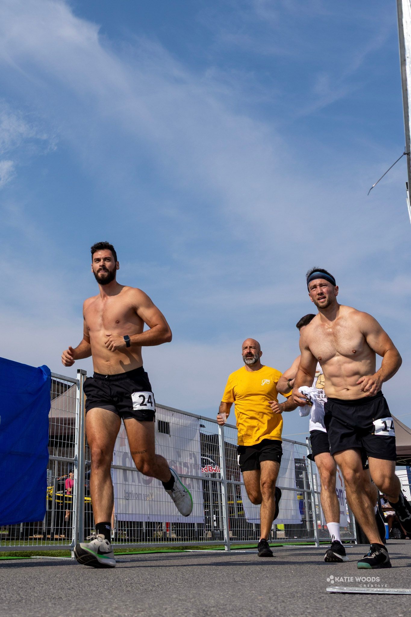 Trois hommes participent à une course sous un ciel bleu éclatant.