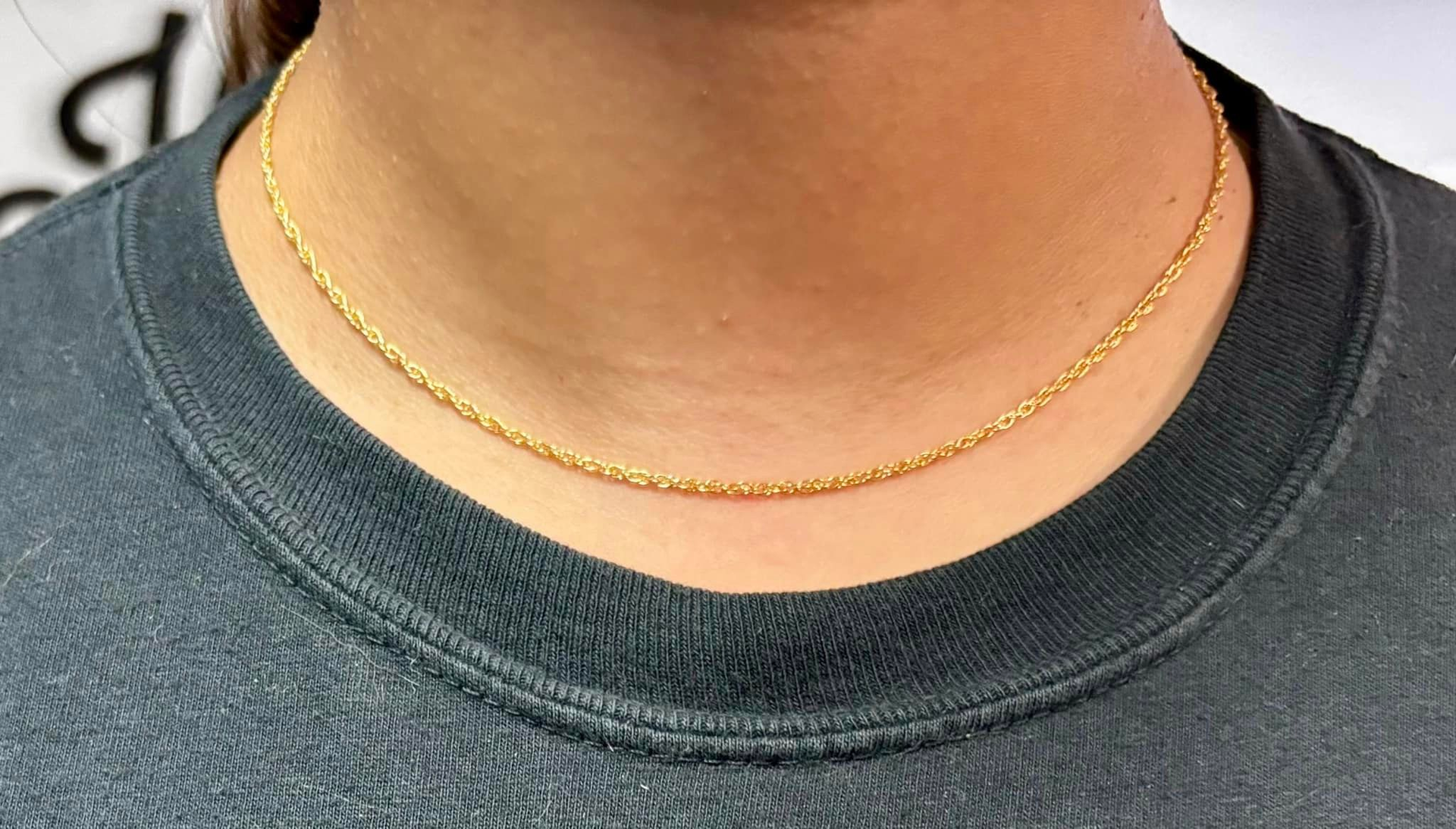 A woman s wearing a necklace.