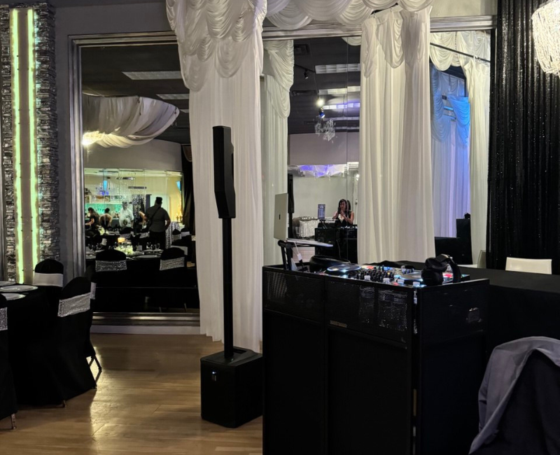 A room filled with balloons and a flower wall.