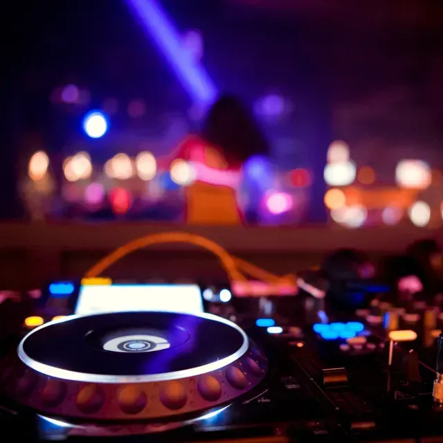A close up of a dj 's mixer in a dark room