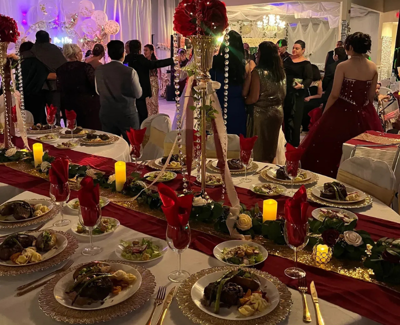 A large room with tables and chairs set up for a wedding reception.