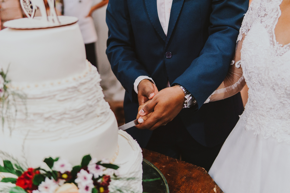 A large room with tables and chairs set up for a wedding reception.