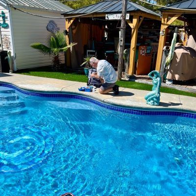Grey Shark Pool Services testing the pool water.