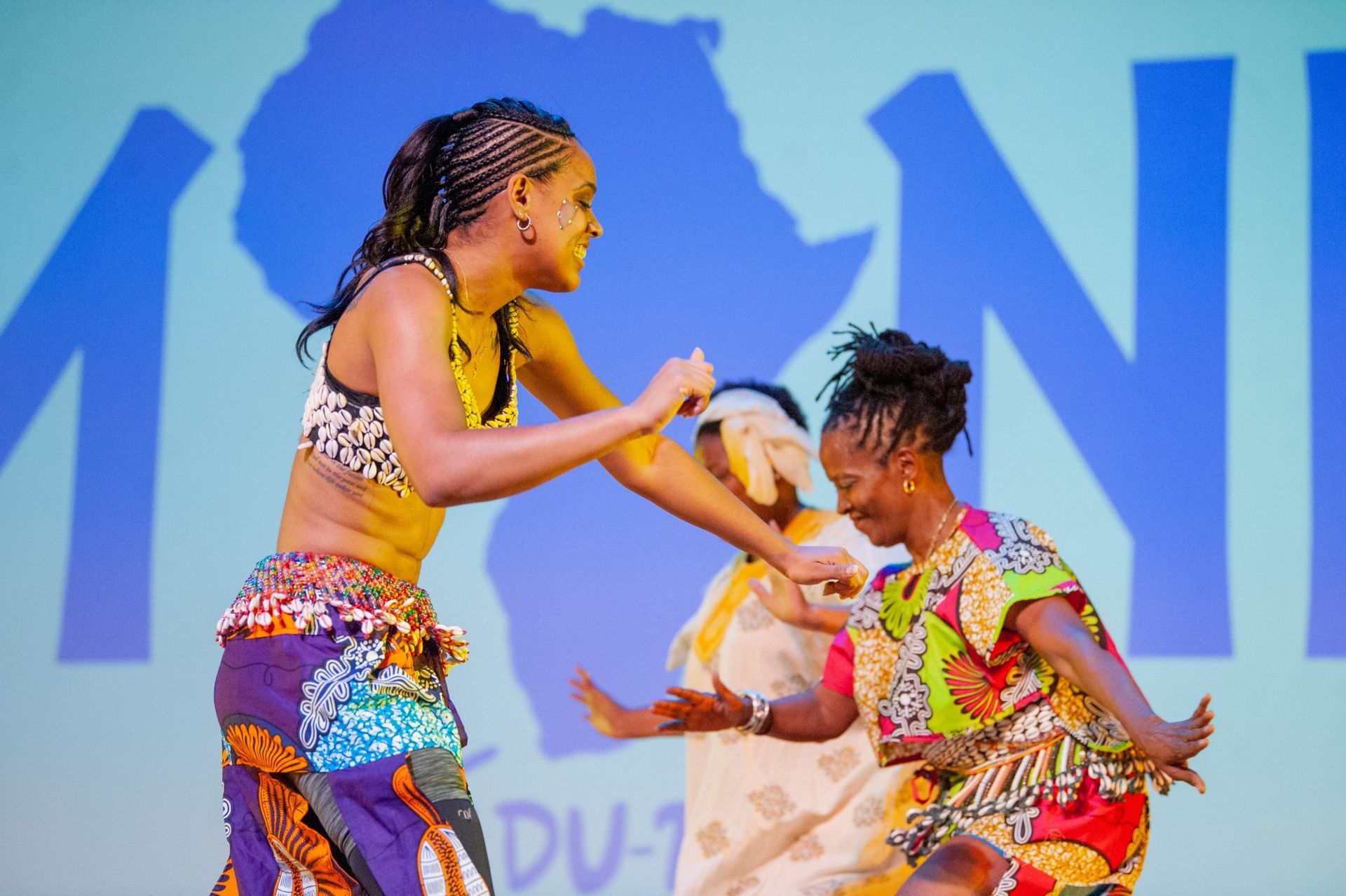 Three women dance on stage