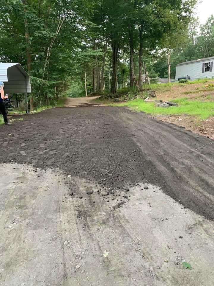Gravel driveway leading to trees