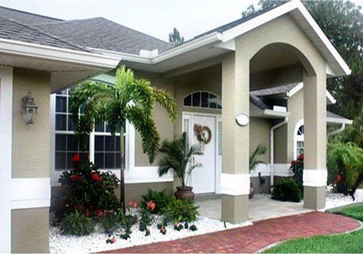 A house with a palm tree in front of it