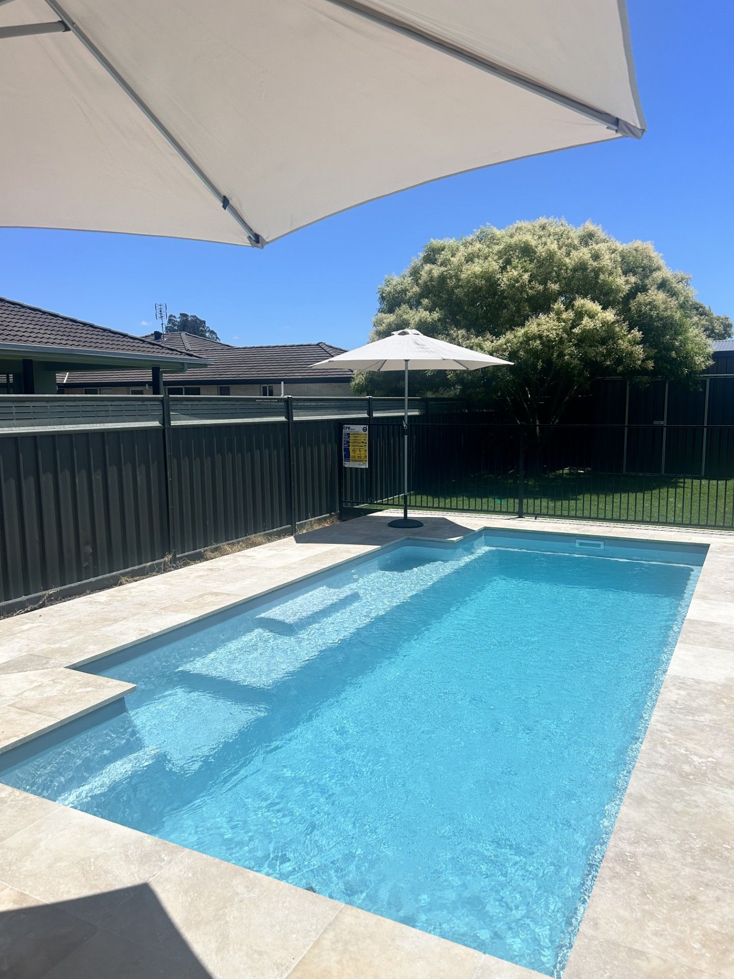There is a Swimming Pool in the Backyard of a House — Clarence Valley Pools In Yamba, NSW