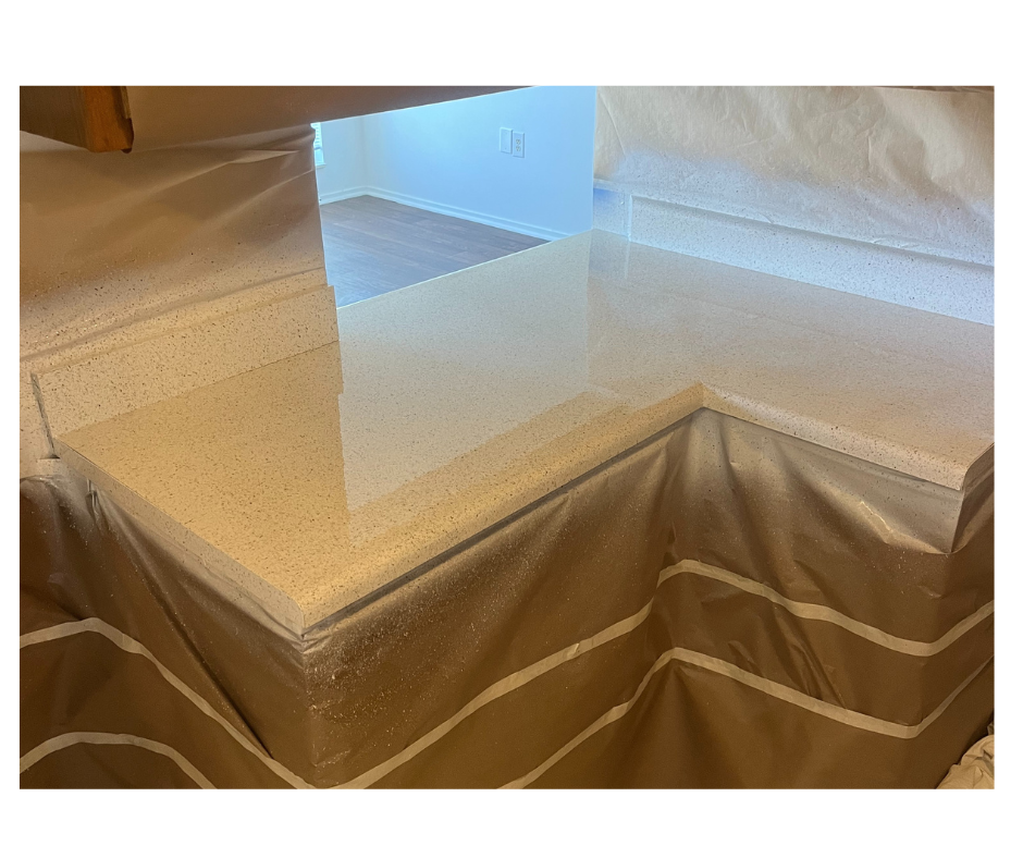 A person is walking on a concrete surface with a broom.