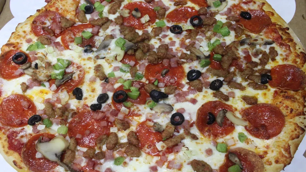 Pizza with pepperoni, ham, sausage, onions, mushrooms, green peppers and black olives.