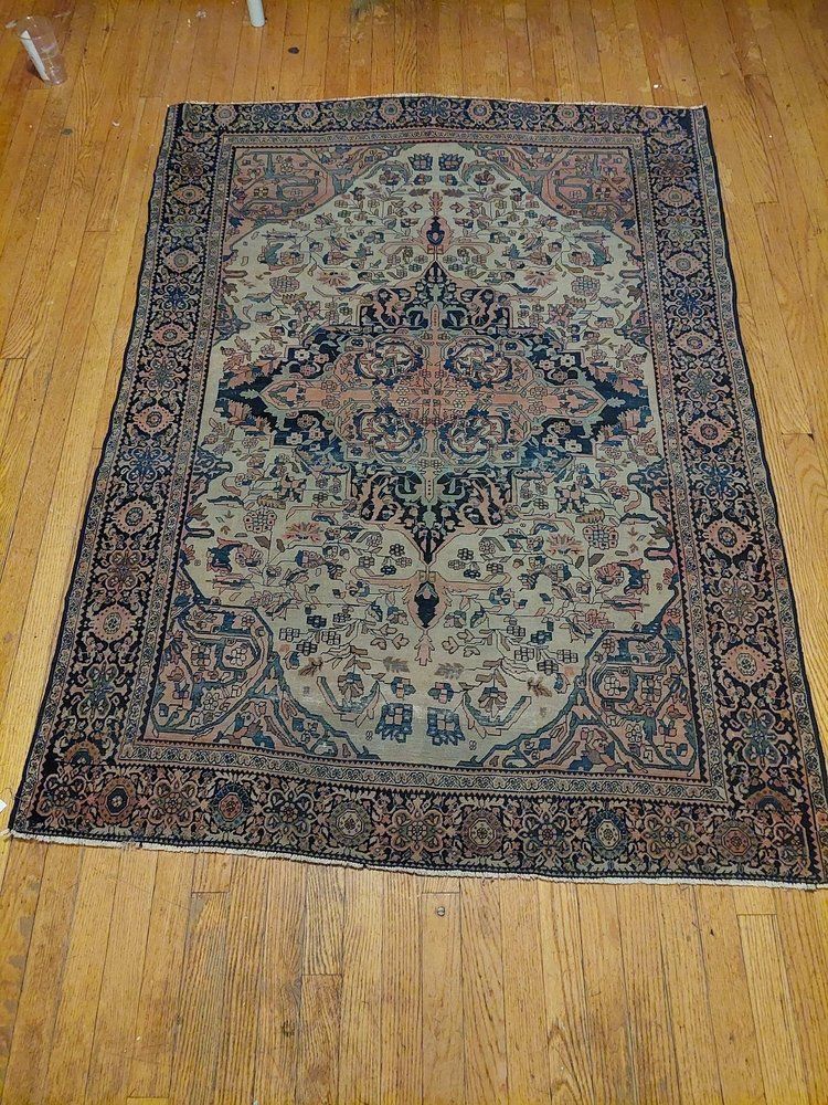 A rug is sitting on a wooden floor.