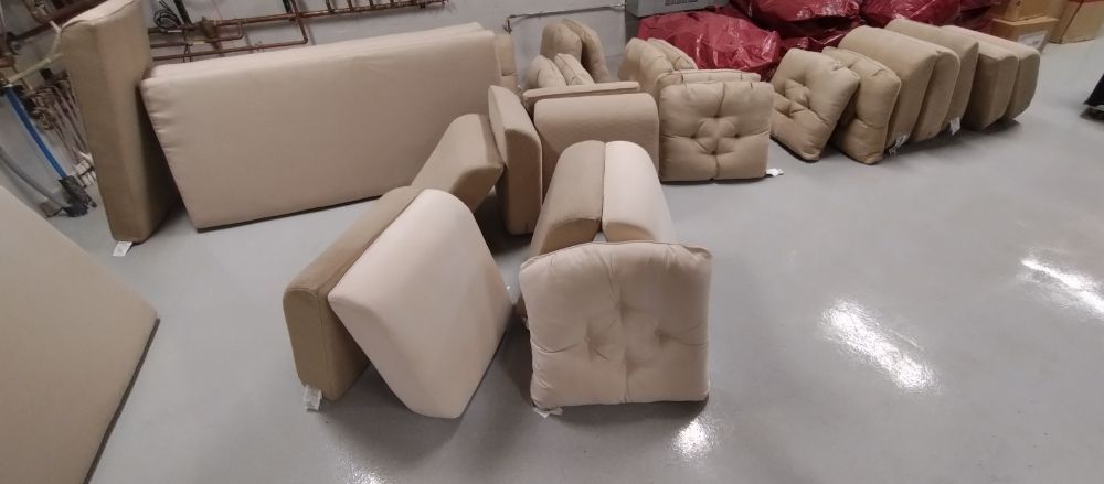 A warehouse filled with lots of furniture and ottomans.