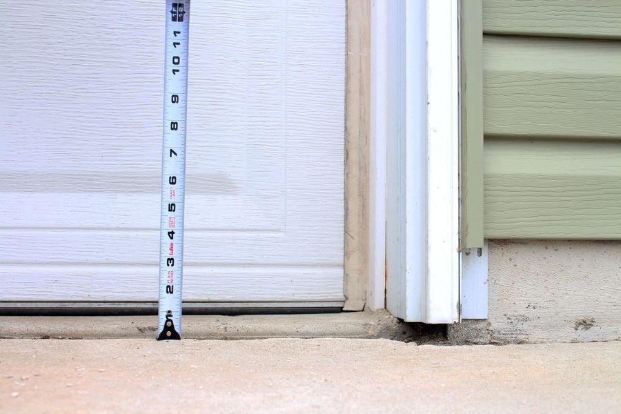 A tape measure measures the height of a garage door