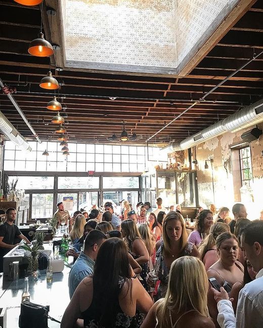 A large group of people are sitting at tables in a restaurant.