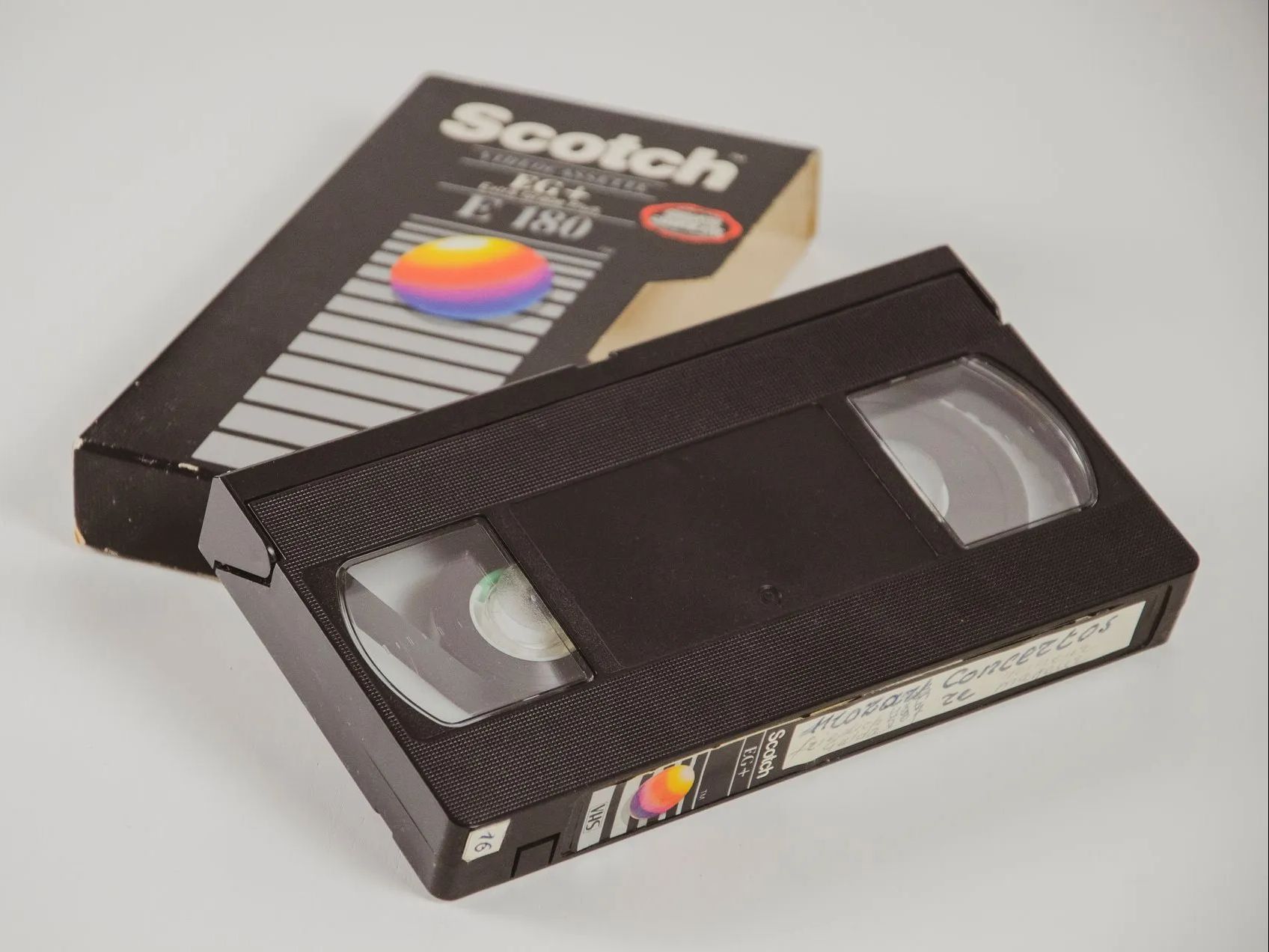 a living room with a yellow chair and a calendar on the wall .