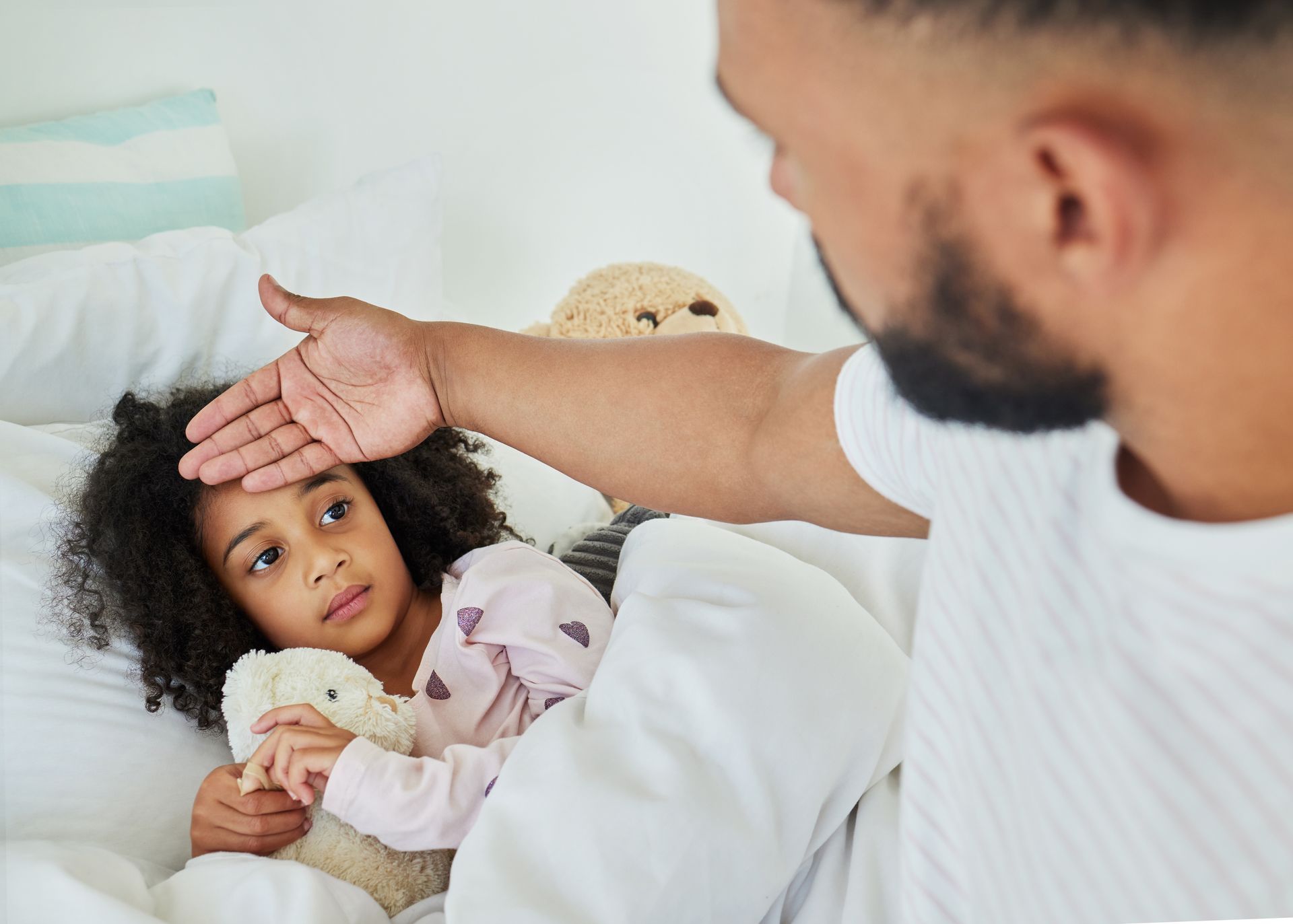 Parent touching child's forehead for fever