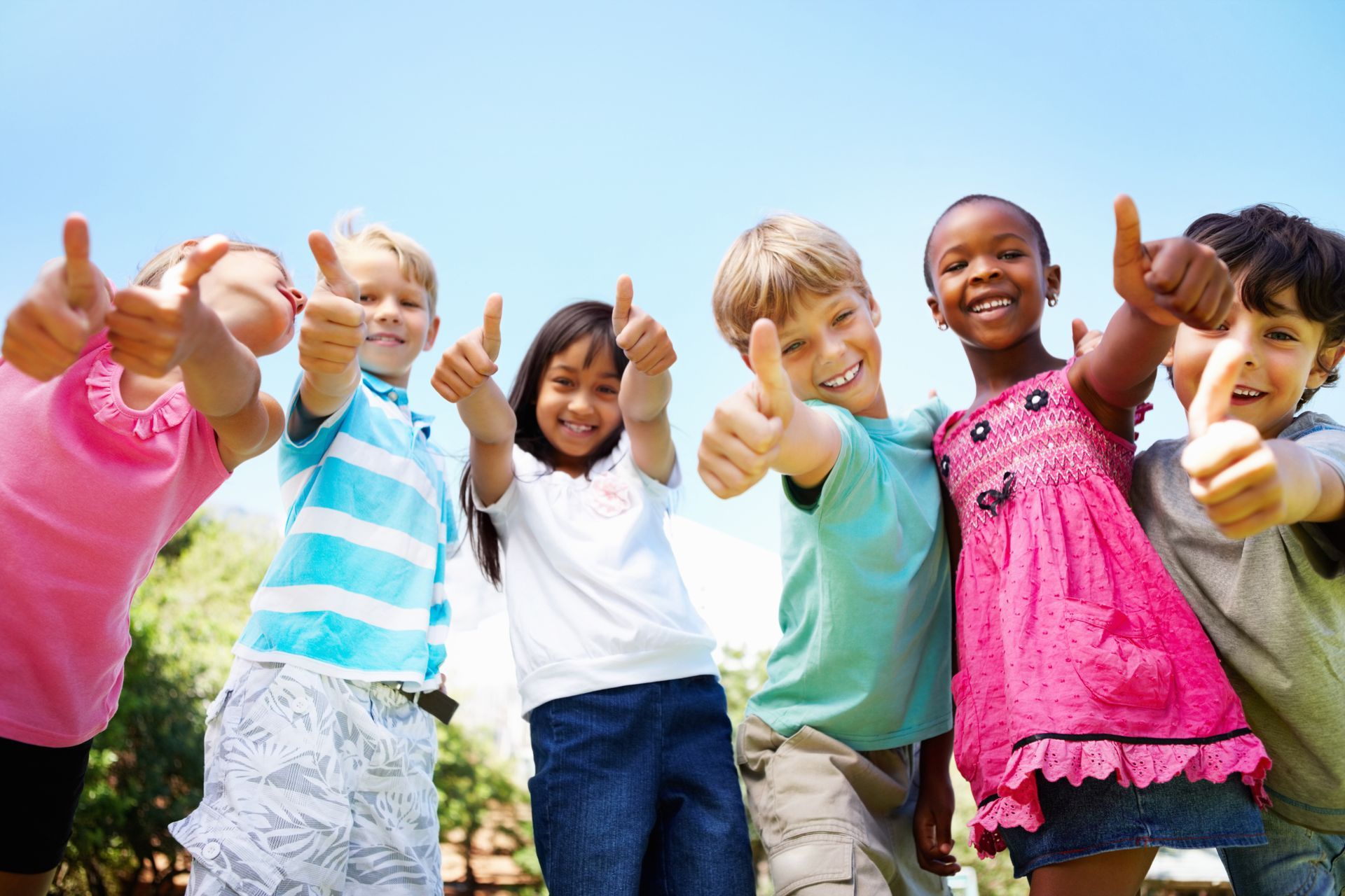 Group of children giving thumbs up