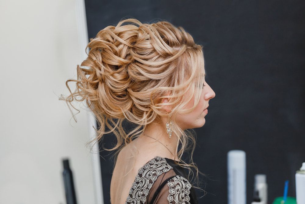 A Woman is Getting Her Hair Done in a Salon — Talking Heads Hair Design in Gympie, QLD