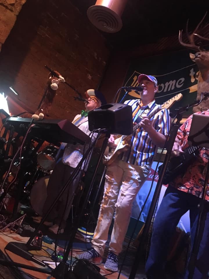 A group of men are playing instruments on a stage.