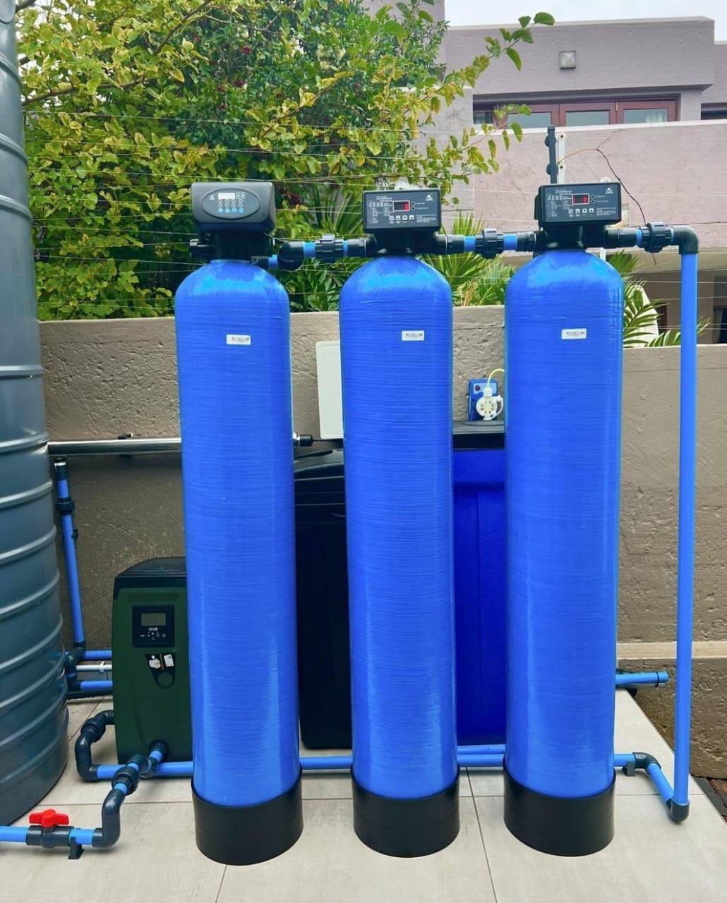 Three blue water filters are lined up next to each other