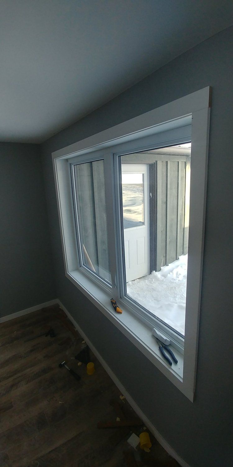 There is a large window in the middle of a room.