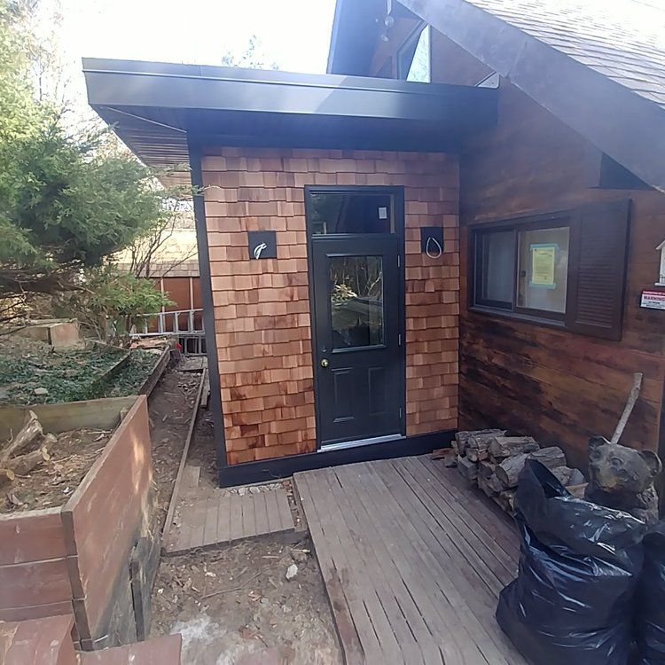 A brick building with a black door and a window