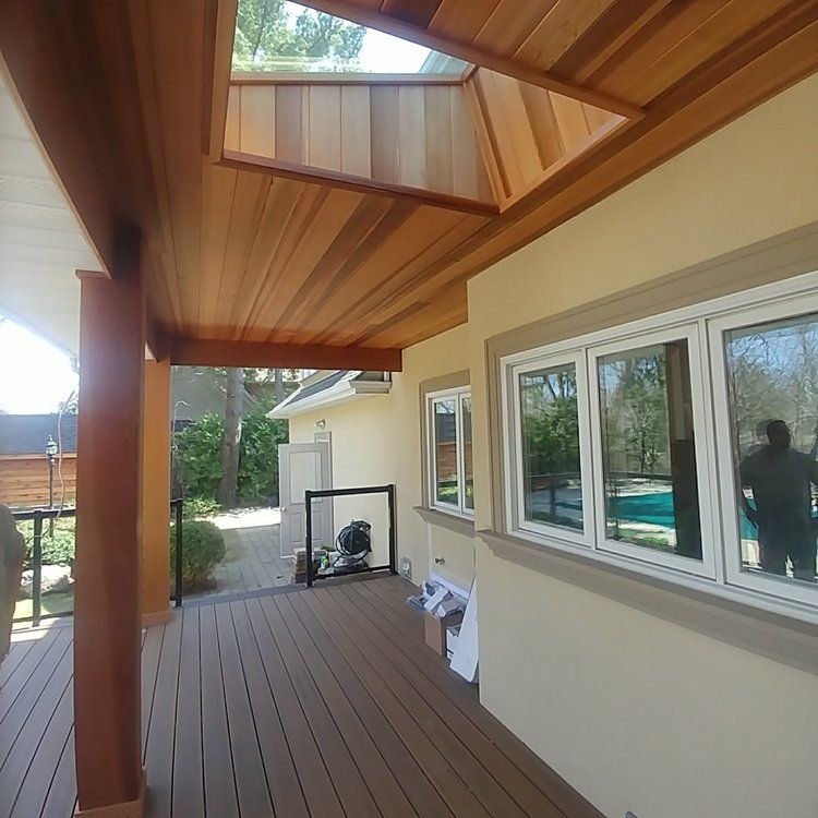 A house with a wooden deck and a lot of windows