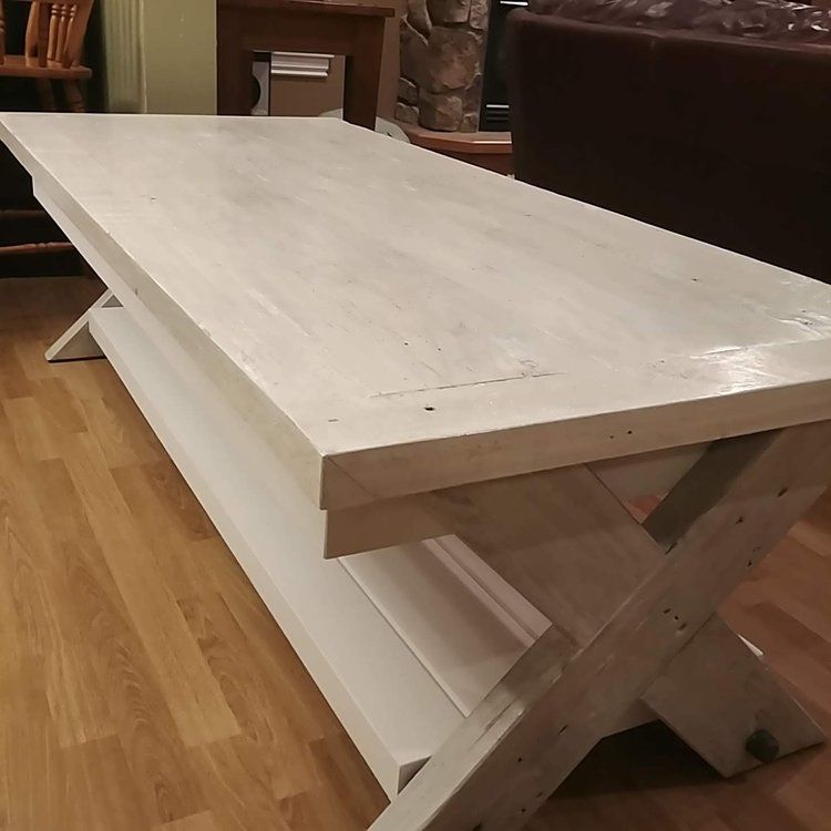 A white wooden table with a shelf underneath it