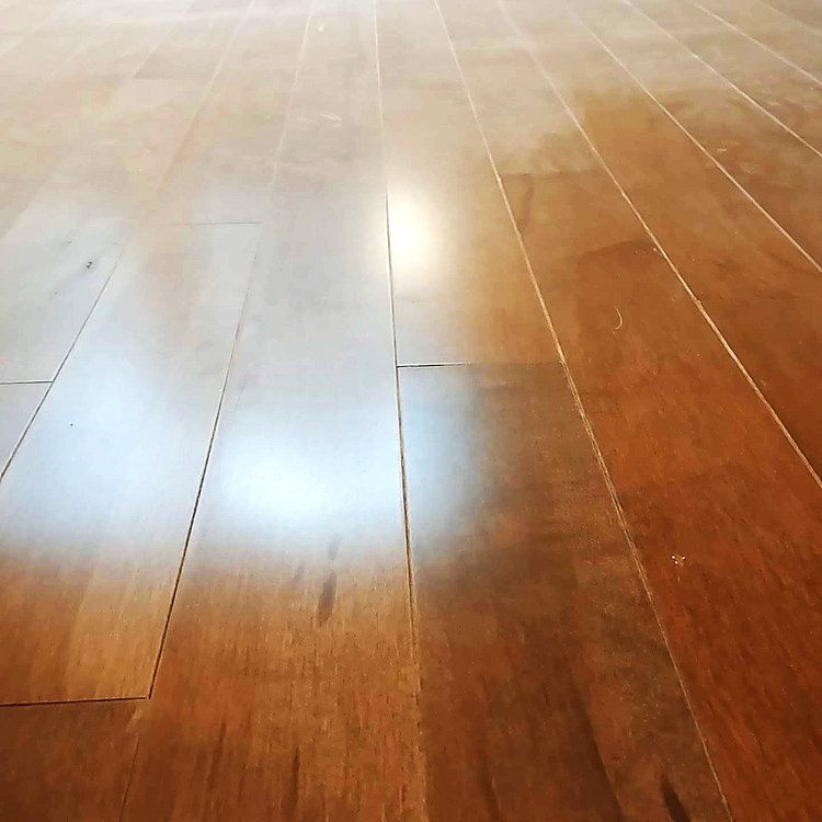 A close up of a wooden floor with a light shining on it.
