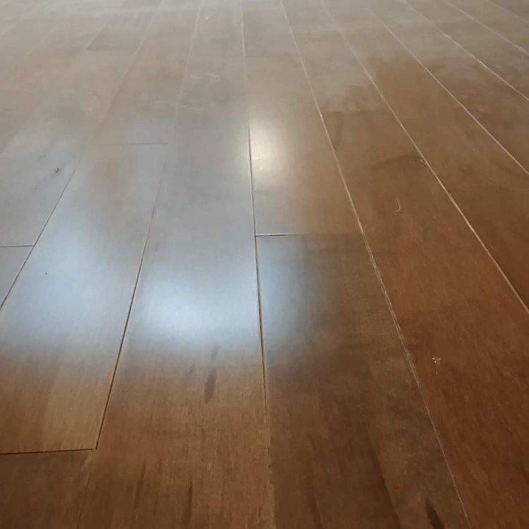 A close up of a wooden floor in a room.