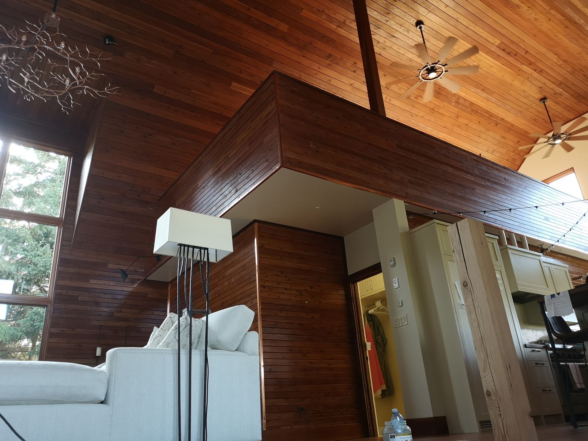A living room with a white couch and a ceiling fan