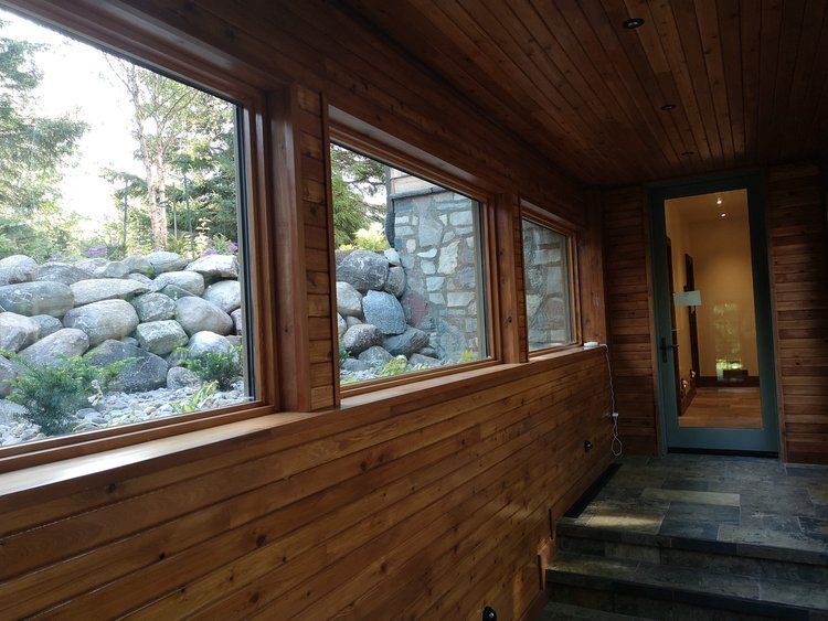 A room with a lot of windows and a door