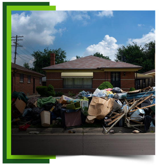 A pile of thrown garbage in front of the house