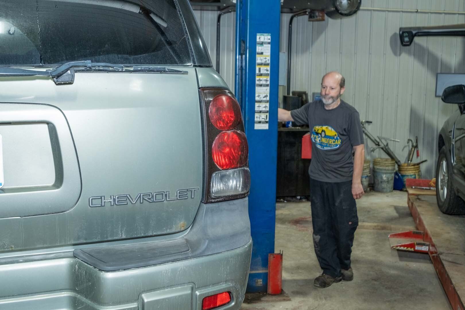 Our Mechanic is Lifts a Vehicle - Phil's Complete Auto Repair