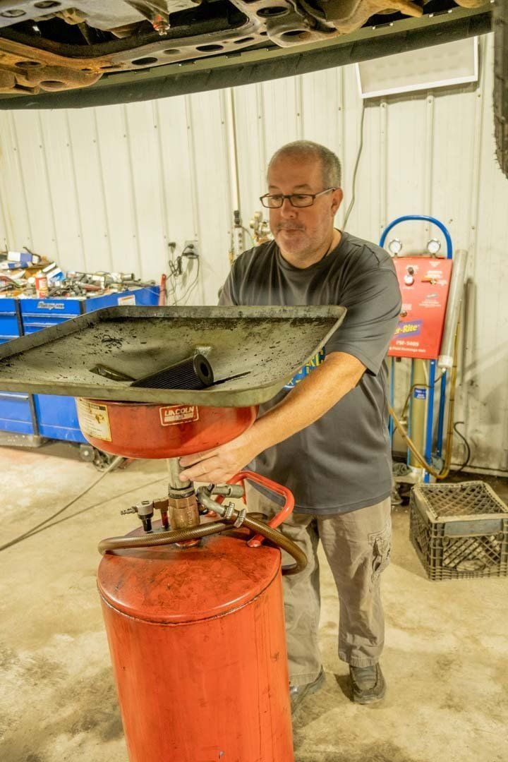 A Technician Drains the Engine Oil - Phil's Complete Auto Repair