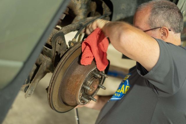 Our Technician is Cleanign Brake Pad in Clinton, MI - Phil's Complete Auto Repair