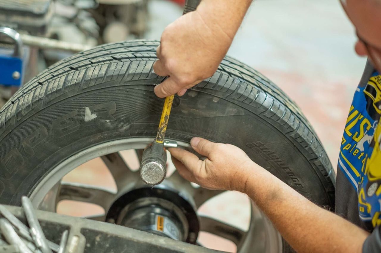 Our Certified Mechanic is Working on a Tire in Clinton, MI - Phil's Complete Auto Repair