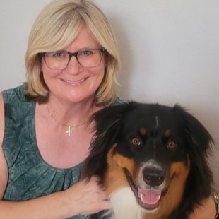 a woman with glasses and her dog