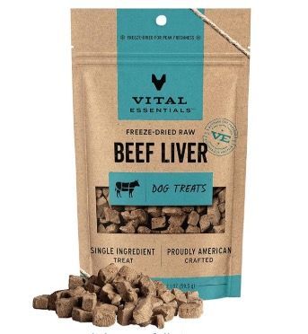 Vital Essentials freeze-dried beef liver dog treats in a brown pouch with a teal label, with a pile of treats in front.