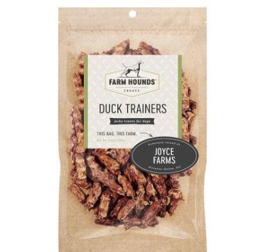 A bag of Farm Hounds Duck Trainers jerky dog treats, featuring a Joyce Farms branding label on a neutral paper background.
