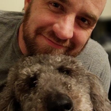 a man with a beard is petting a small dog .