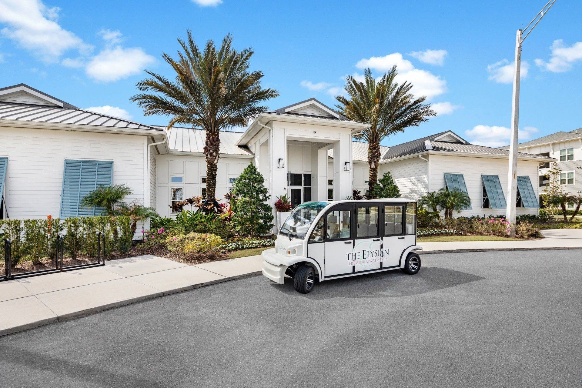 Apartment Leasing Building Front Door with Apartment Golf Cart | The Elysian