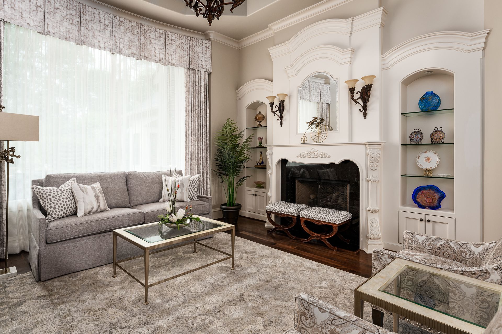 A kitchen with white cabinets , white counter tops , and a large island.