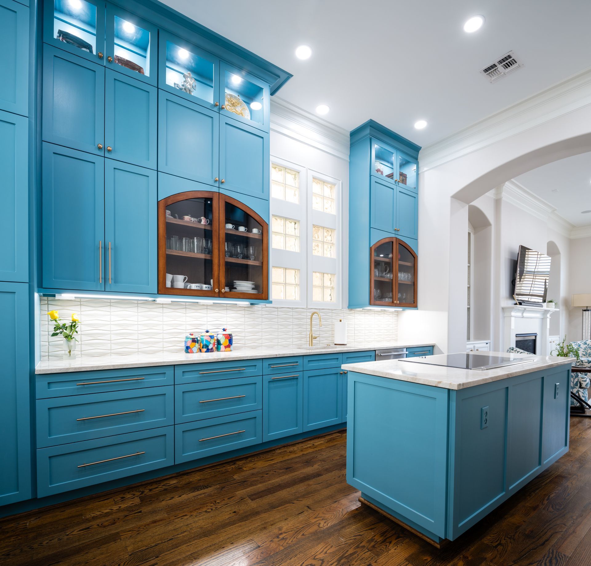 A kitchen with white cabinets , stainless steel appliances , and a stove top oven.