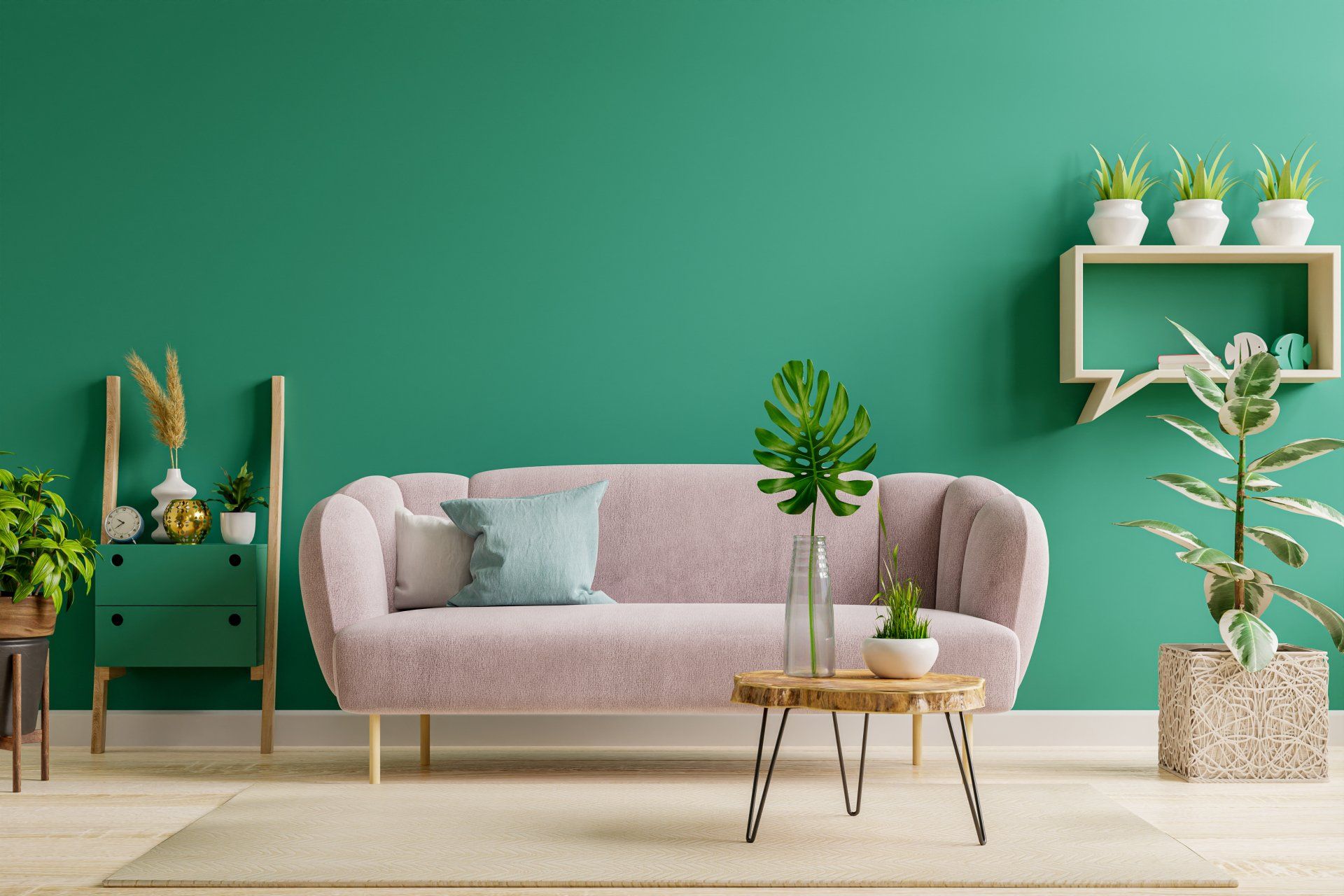 A living room with a pink couch and green walls.