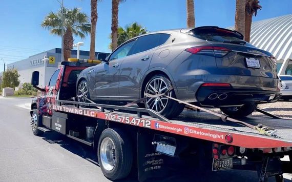 A car is being towed by a tow truck.