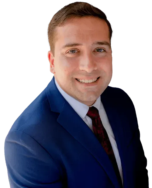 Smiling man in a blue suit with a white shirt and red tie against a white background