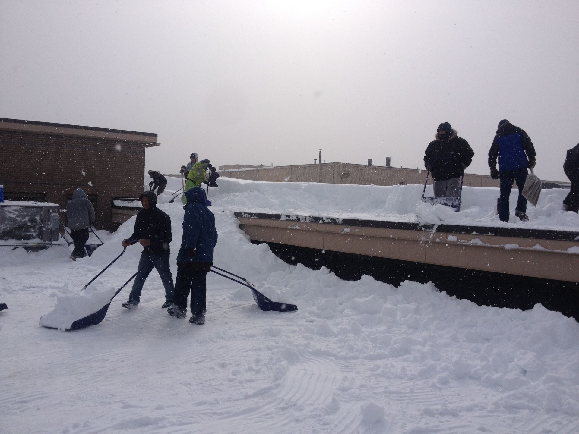 Men Removing Snow — Springfield, MA — Sun Roofing Inc