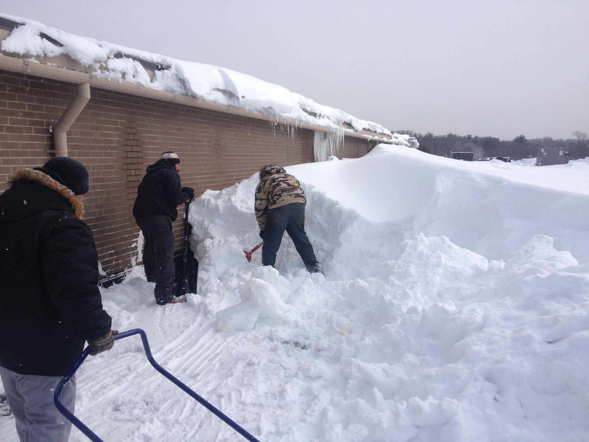 Men Removing Big Pile of Snow — Springfield, MA — Sun Roofing Inc