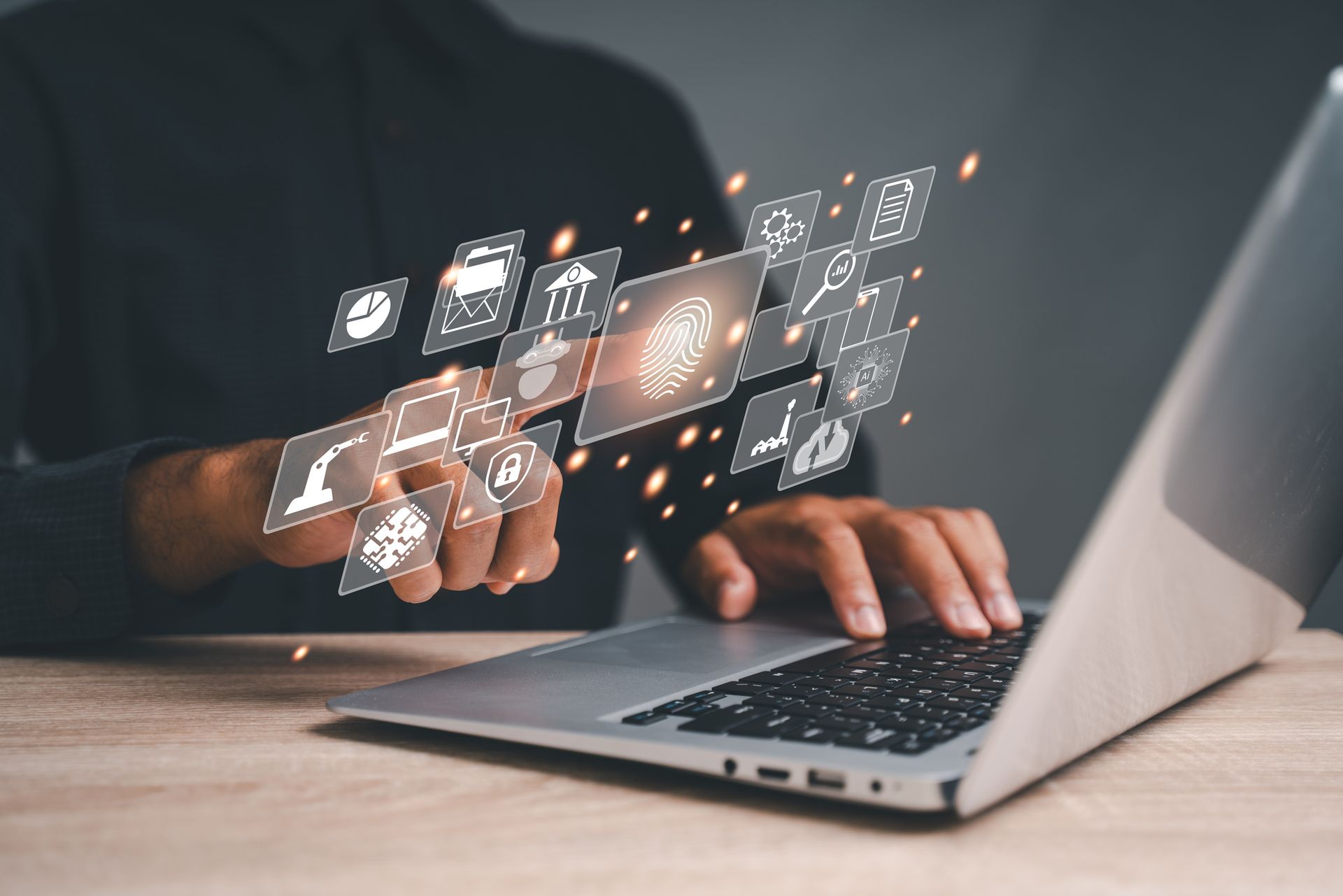 A man using a laptop with floating digital icons representing various applications and tools